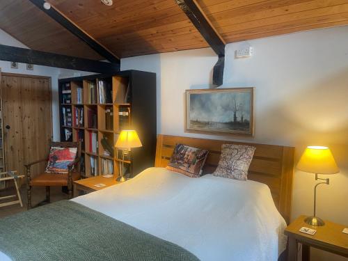 a bedroom with a bed and a book shelf at Appalachian Spring B&B in Dartington