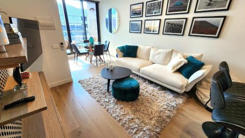 a living room with a couch and a table at Resort-style Exec 1 Bed with study in Port Melbourne in Melbourne