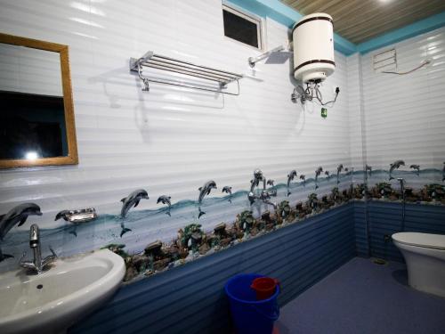a bathroom with a bunch of water faucets at Blissful Mountain Kyarki in Shivpuri