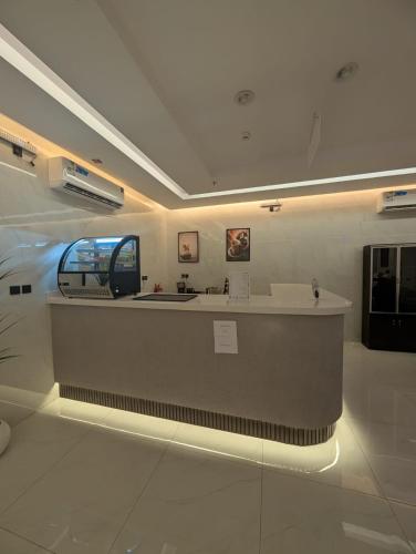 a lobby with a reception counter in a building at فندق قربان in Al Madinah