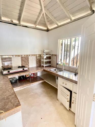 a kitchen with a sink and a counter top at LAKE HOUSE - La maison VEDA in Habaraduwa