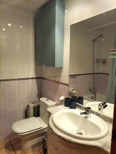 a bathroom with a sink and a toilet and a mirror at PoolParadise Tu mejor opción in San Jorge