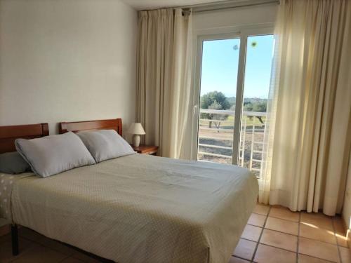 a bedroom with a bed and a large window at PoolParadise Tu mejor opción in San Jorge