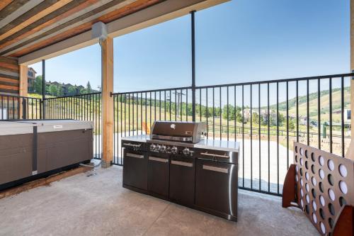 a kitchen with a stove and a large window at Summit Unit 1303 in Granby