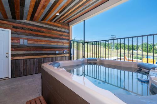 a large bath tub in a room with a balcony at Summit Unit 1303 in Granby