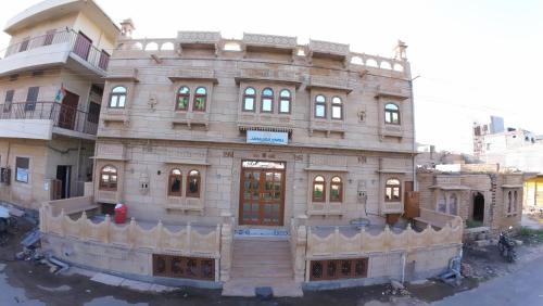 a large building in front of a building at Jaisalmer Haveli in Jaisalmer