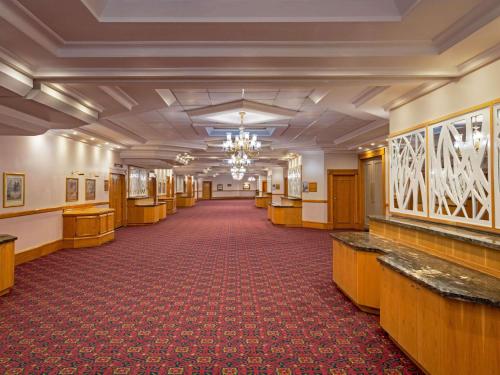 an empty hallway in a building with a chandelier at Mercure Hotel Windhoek in Windhoek