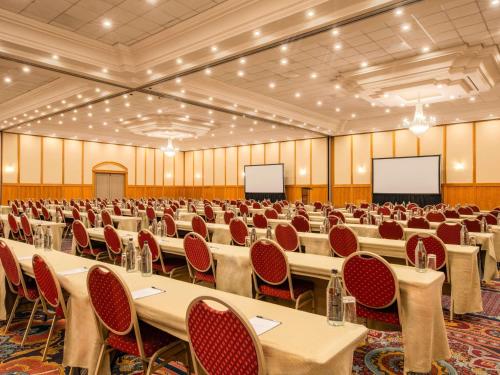 a large room with tables and chairs in it at Mövenpick Hotel Windhoek in Windhoek