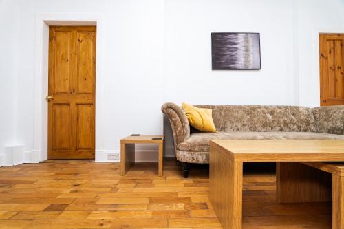 a living room with a couch and a table at 2 Bedroom House - Free Parking in Annan