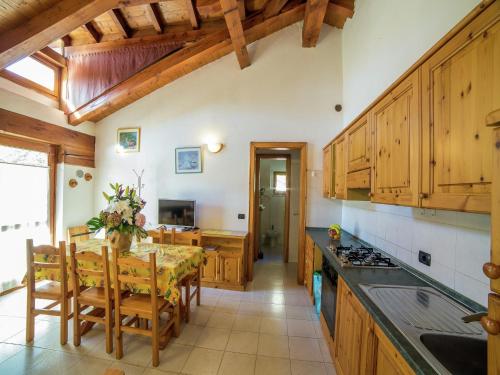 a kitchen with a table and a dining room at Apartment in Antey-Saint-André near Ski Lifts in Antey-Saint-André