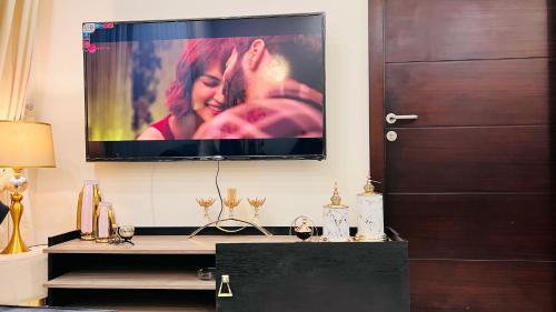 a flat screen tv hanging on a wall at Penta Square Signature Apartments DHA Phase 5 Lahore in Lahore