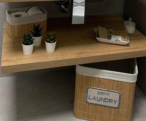 a wooden counter with potted plants on a shelf at Apa Sicula in Avola
