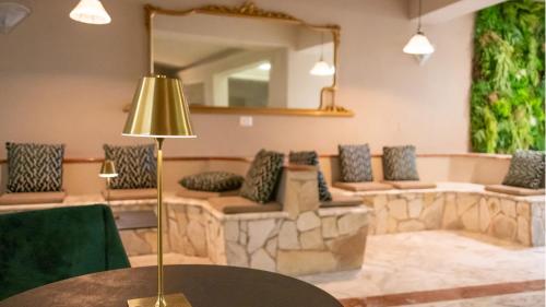a room with a couch and a table with a mirror at Hotel Calanca in Marina di Camerota