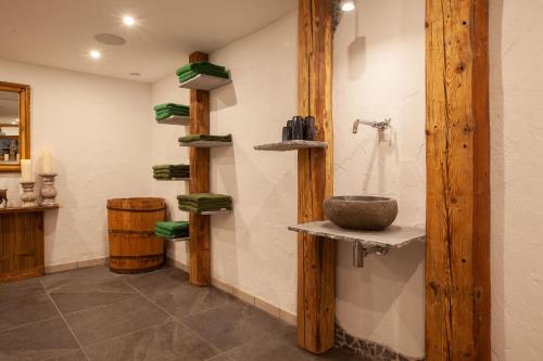 a bathroom with a stone sink on a wall at Das Landhaus in Pfronten