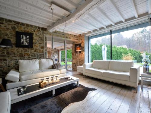 a living room with two white couches and a table at Stylish Stay with Pool, Jalhay in Jalhay
