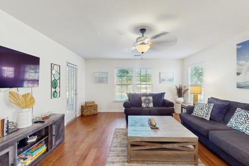 a living room with a couch and a table at Haven On The Links in Pawleys Island