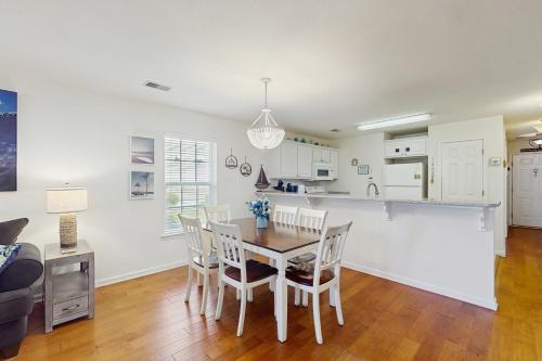 a kitchen and dining room with a table and chairs at Haven On The Links in Pawleys Island