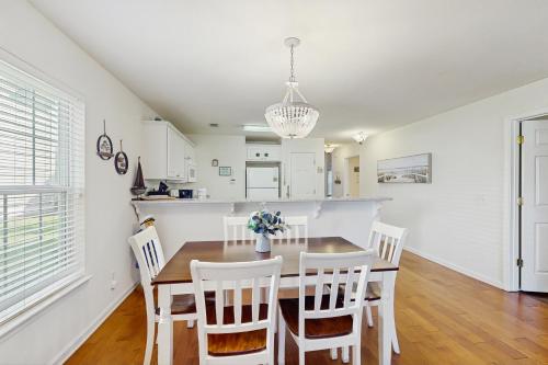 a kitchen and dining room with a table and chairs at Haven On The Links in Pawleys Island