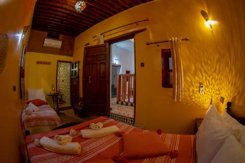 a bedroom with two beds with towels on them at Riad Misk Fez in Fès