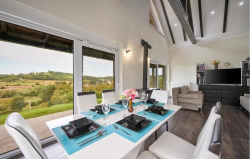 a dining room with a table and chairs and a large window at Stunning Home In Strigova With Wifi in Štrigova