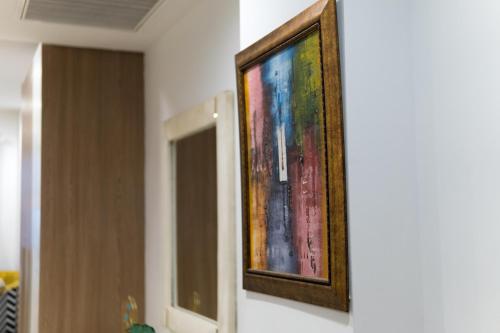 a painting is hanging on a wall at Penta Square Signature Apartments DHA Phase 5 Lahore in Lahore