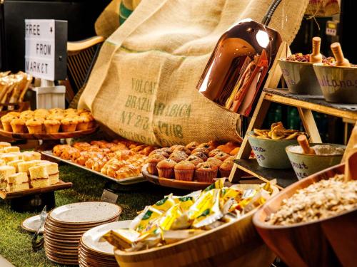 a buffet of pastries and other food on a table at ibis budget London Heathrow Central in Hounslow