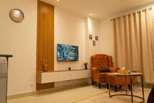 a waiting room with a chair and a table at Penta Square Signature Apartments DHA Phase 5 Lahore in Lahore