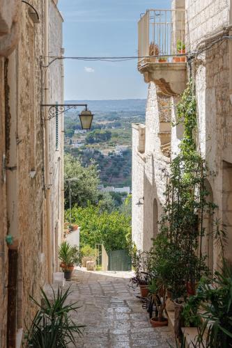 an alley in an old town with a street light at CRIO - Experiences at home in Cisternino