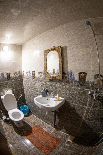 a bathroom with a sink and a toilet and a mirror at Riad Misk Fez in Fès