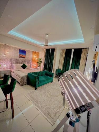 a living room with a bed and a couch at Penta Square Signature Apartments DHA Phase 5 Lahore in Lahore