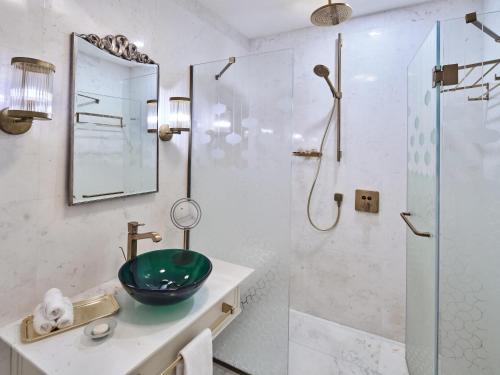 a bathroom with a sink and a shower at Club Privé By Rixos Saadiyat in Abu Dhabi