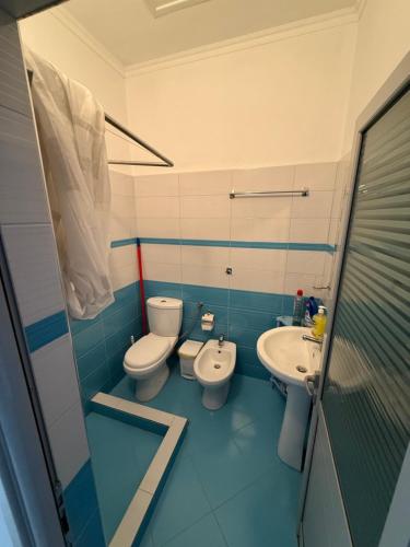 a bathroom with two toilets and a sink at SunHome Ismailaj in Poliçan