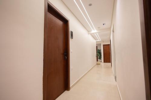 a hallway with a wooden door and a hallway sidx sidx at Imperial Luxury Hotel in Cairo