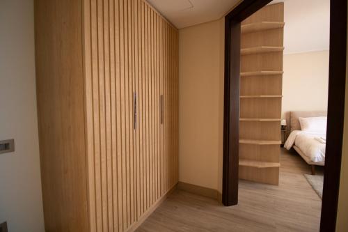 a bedroom with a closet and a bed at Luxury Rooms in the Heart of Pyramids in Kafr Ghaţāţī