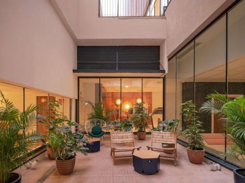 a room filled with lots of potted plants at Ibis Styles Sevilla City Santa Justa in Seville
