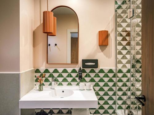a bathroom with a sink and a mirror at Ibis Styles Sevilla City Santa Justa in Seville