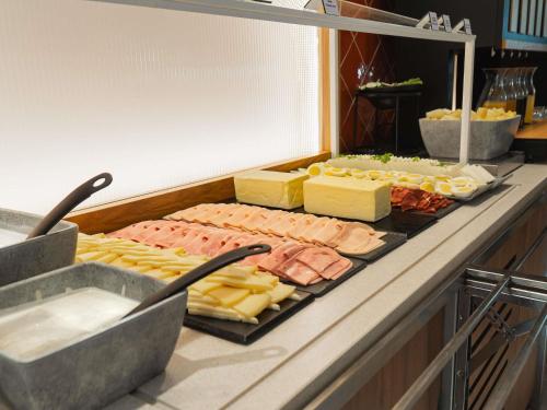 a buffet line with cheese and meats and cheeses at Ibis Styles Sevilla City Santa Justa in Seville