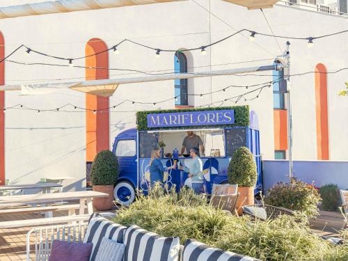 a food truck with people sitting in the front at Ibis Styles Sevilla City Santa Justa in Seville