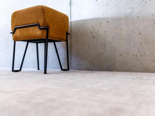 a brown chair sitting in a corner of a room at Hotel Valkenburg by Mercure - Next to Shimano Experience Center in Valkenburg
