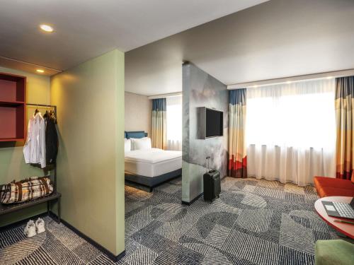 a hotel room with a bed and a television at ibis Styles St Margrethen Bodensee in Sankt Margrethen