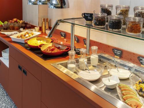 a buffet line with many different types of food at ibis Styles St Margrethen Bodensee in Sankt Margrethen