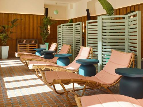 a row of chairs and tables in a room at 25hours Hotel Indre By in Copenhagen