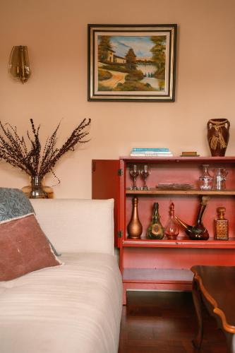 a bedroom with a bed and a shelf with vases at Casa d'Avo - 3BD cosy home in Funchal