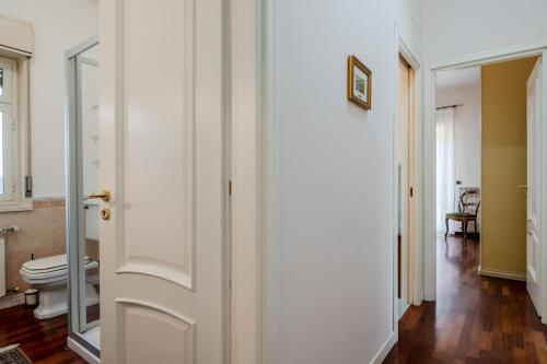 a bathroom with a toilet and a mirror at GuestHost - Trecastagni Elegant & Comfy Apartment in Trecastagni