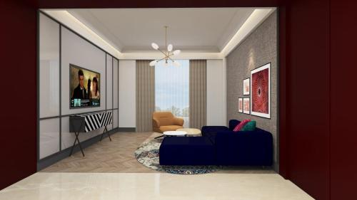 a living room with a blue couch and a chair at Grand Mercure Agra - An Accor Brand in Agra