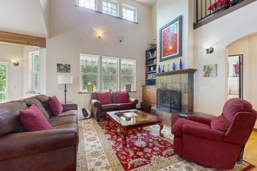 a living room with two couches and a fireplace at House at Eagle Creek in Leavenworth