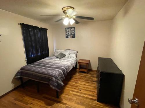 a bedroom with a bed and a ceiling fan at The Monroe House 