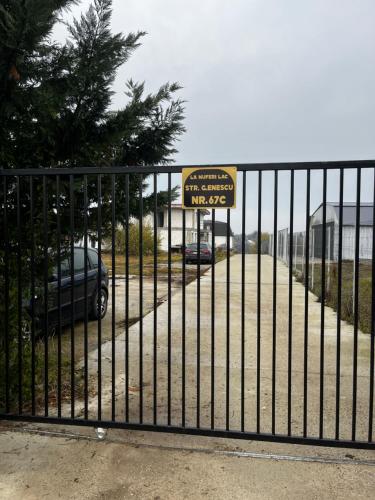 a gate with a sign that reads parking garage wassup at The Lakehouse Snagov Near Therme in Vlădiceasca