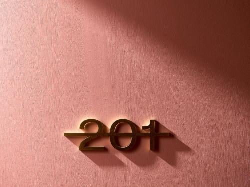 a bronze number on a pink wall at Hotel Morris Sydney, Handwritten Collection in Sydney