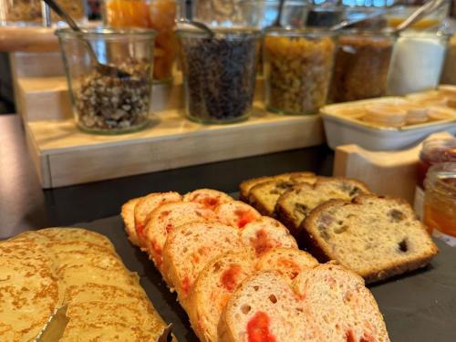a bunch of bread sitting on a counter in a bakery at ibis Lyon Sud Oullins in Oullins